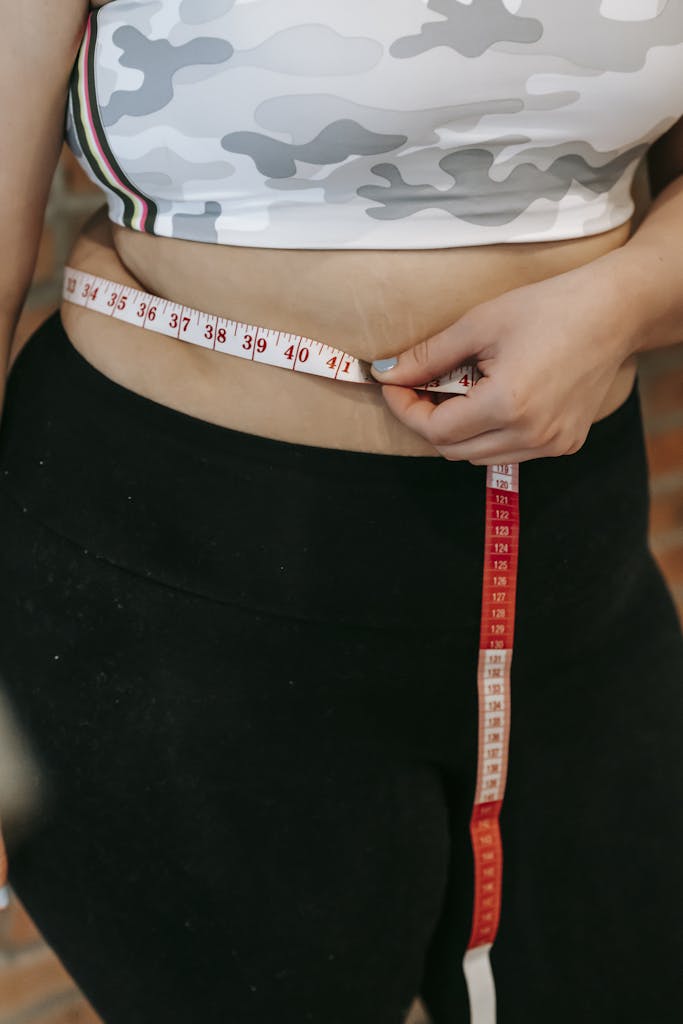 Woman measuring her waist